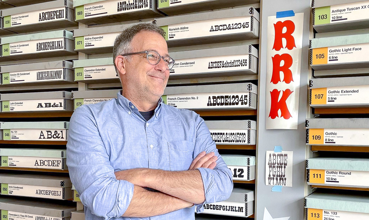 David Shields, wood type scholar, in front of wall of archival boxes containing RRK wood type collection in UT Design Lab