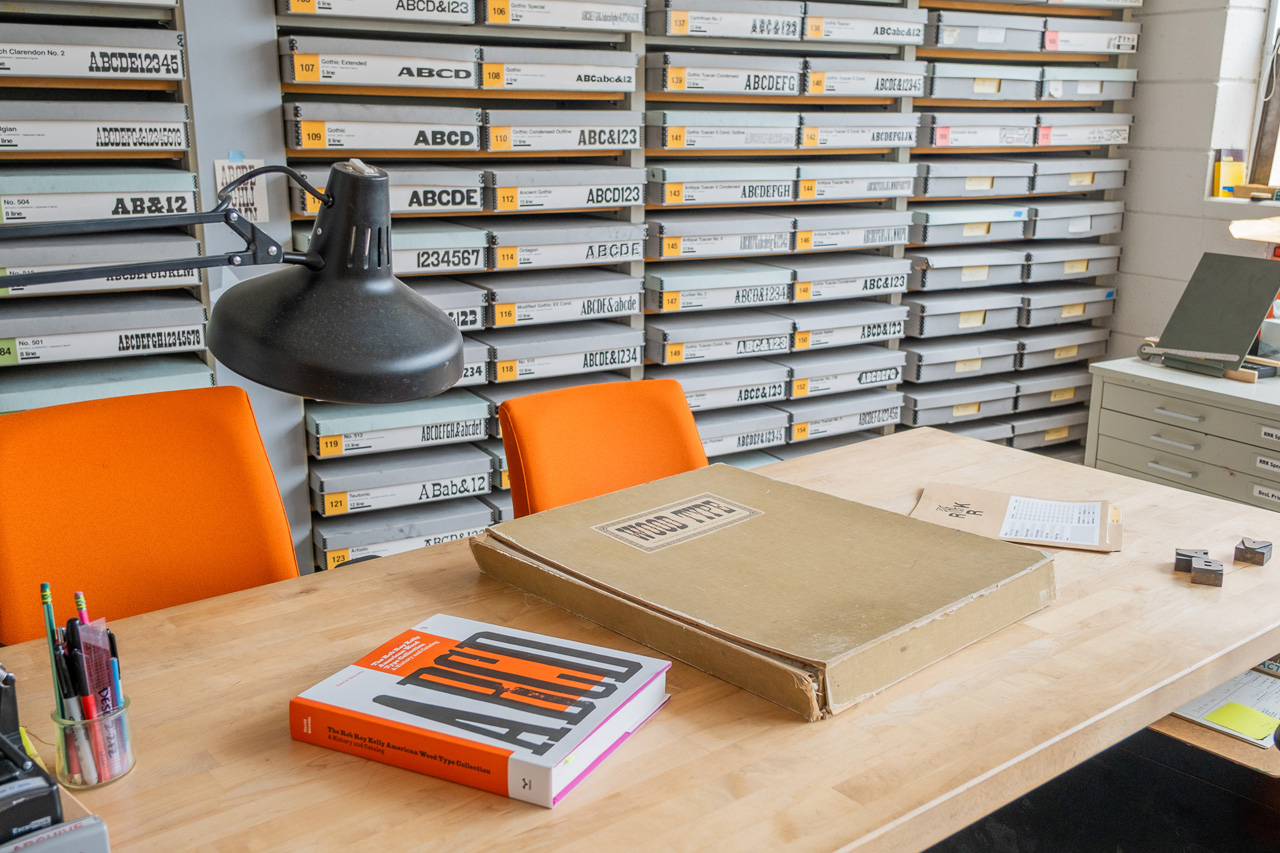 wall of 166 archival boxes in lab office containing RRK wood type collection in UT Design Lab