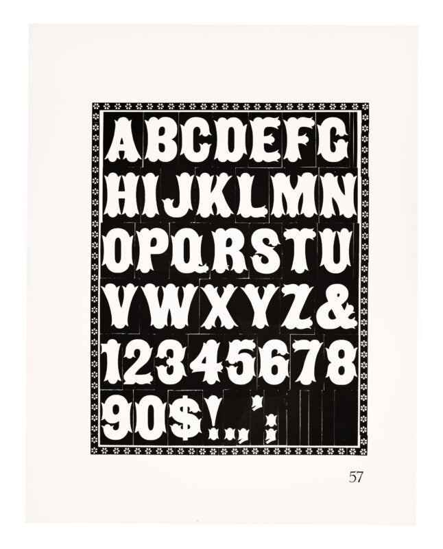 A gothic typeface boxed in by a flower border, printed in black on white paper.