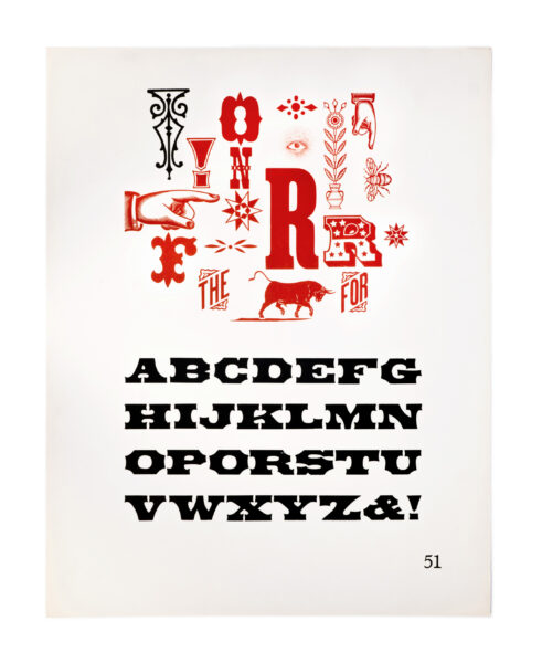 A page from American Wood Types, 1828-1900, Volume I, featuring tuscan type printed in black on white paper. Also included is one index pointer hand, placed amongst the letters.