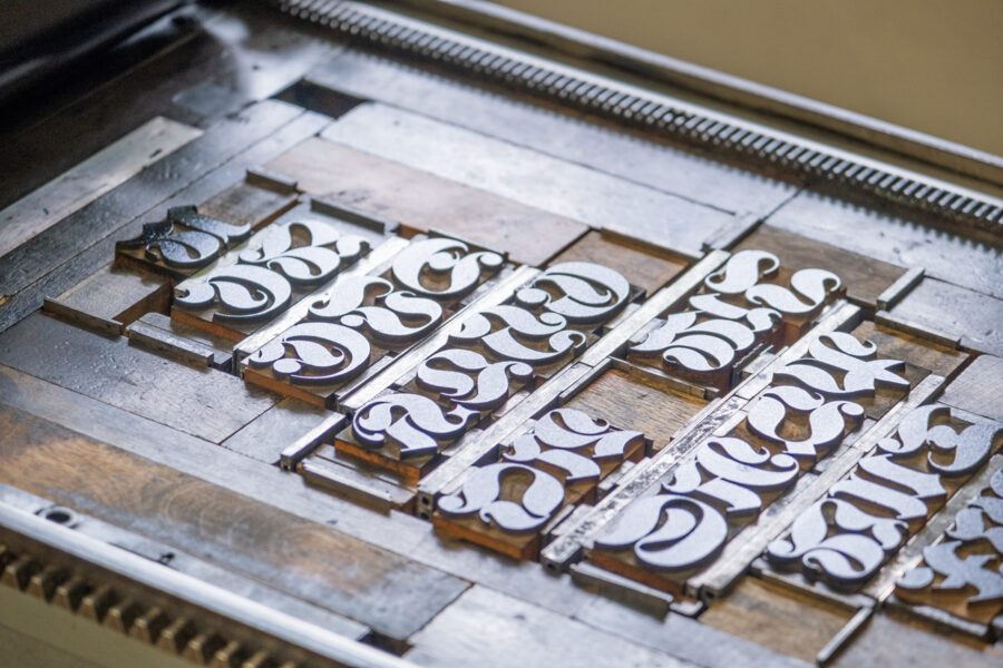 German blackletter script wood type from the RRK collection locked up in a form on Vandercook press bed