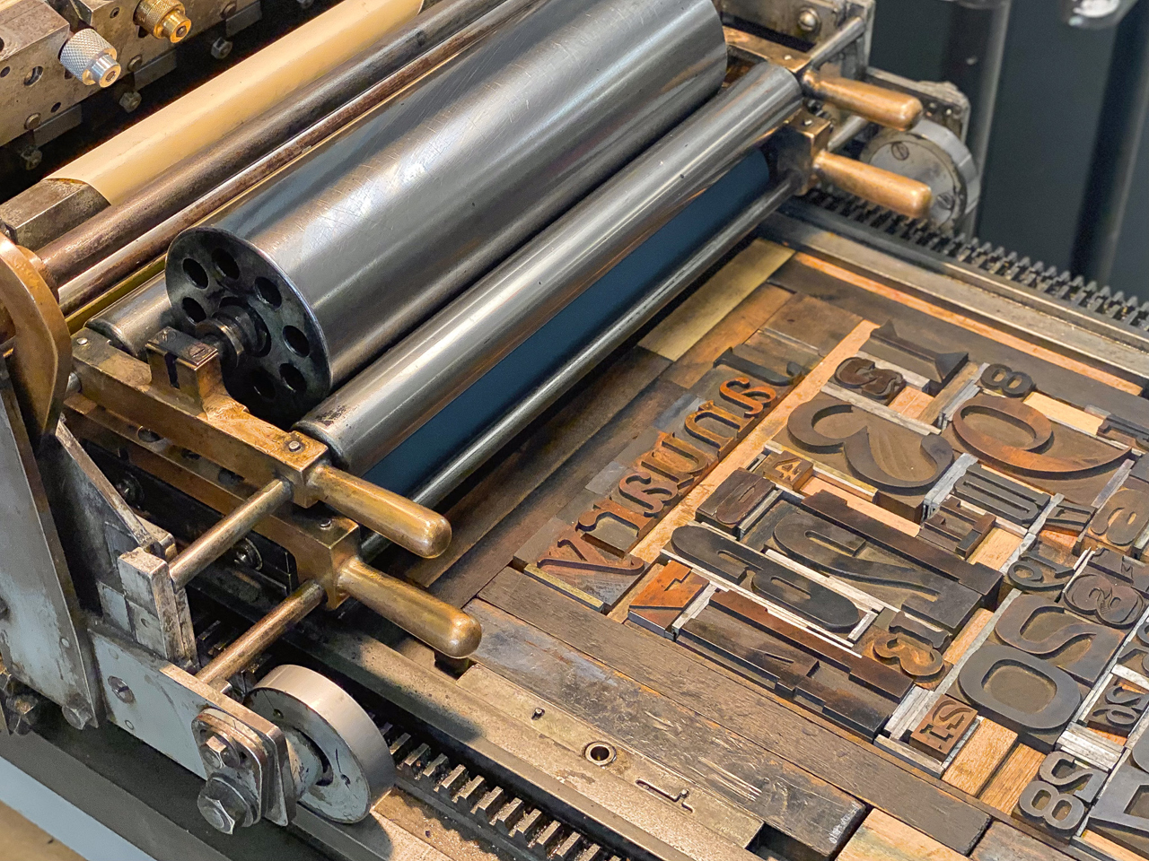 wood type composition in a lock-up on the bed of a Vandercook press in the UT Design Lab