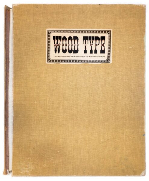 American Wood Types 1828-1900, cover of a folio of wood type print specimens, a brown cloth-wrapped clamshell box with a small title plate